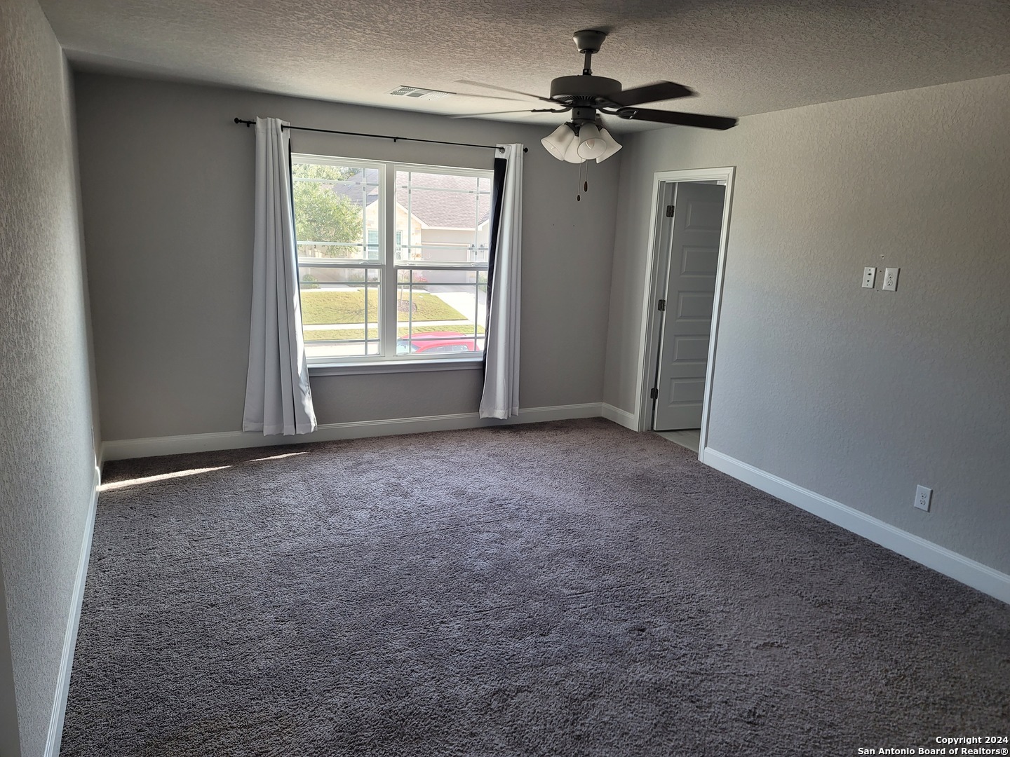 155 Magnolia Circle Boerne, TX 78006 - Photo 8 of 15 an empty room with windows and fan