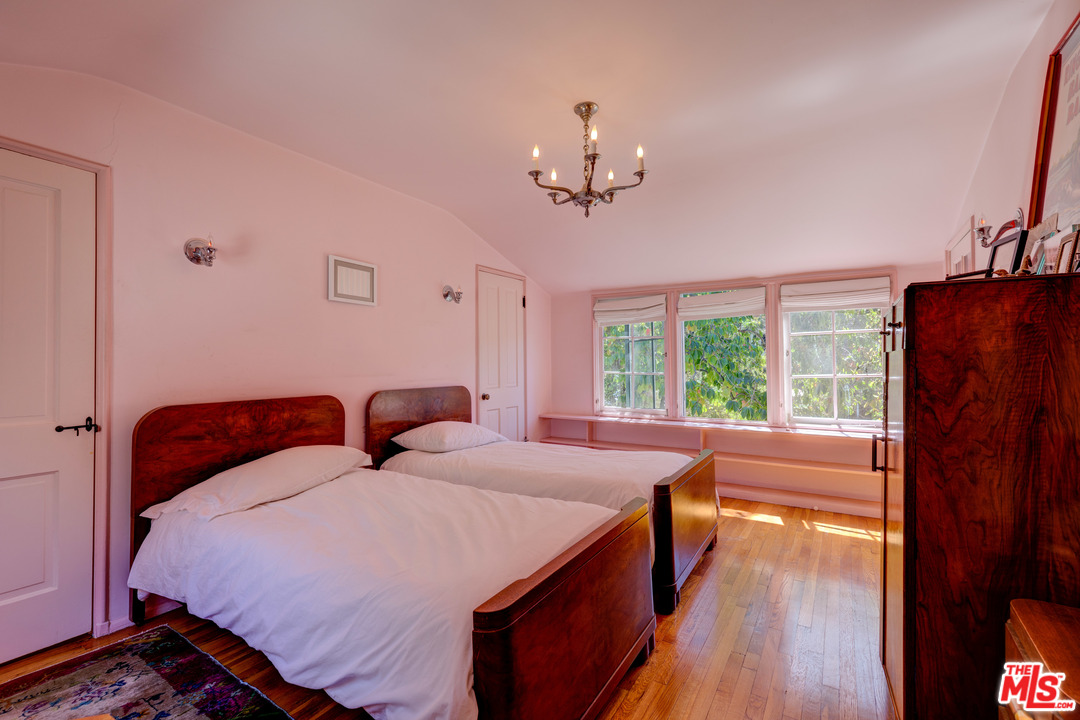 6740 Milner Road Los Angeles, CA 90068 - Photo 20 of 34 a bedroom with a large bed and a chandelier