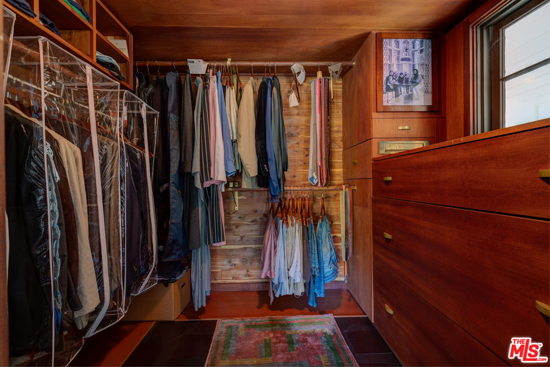 6740 Milner Road Los Angeles, CA 90068 - Photo 25 of 34 a view of walk in closet with clothes and shoes