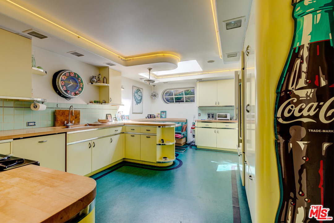 6740 Milner Road Los Angeles, CA 90068 - Photo 8 of 34 a kitchen with a refrigerator a stove top oven and a sink