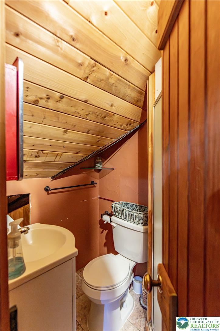 2485 Hieter Road Quakertown, PA 18951 - Photo 51 of 97 A cozy, compact bathroom with warm wood paneling offers functional design.