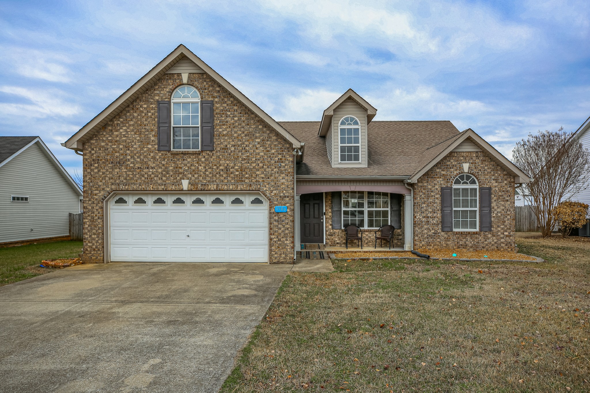 a front view of a house with a yard and garage