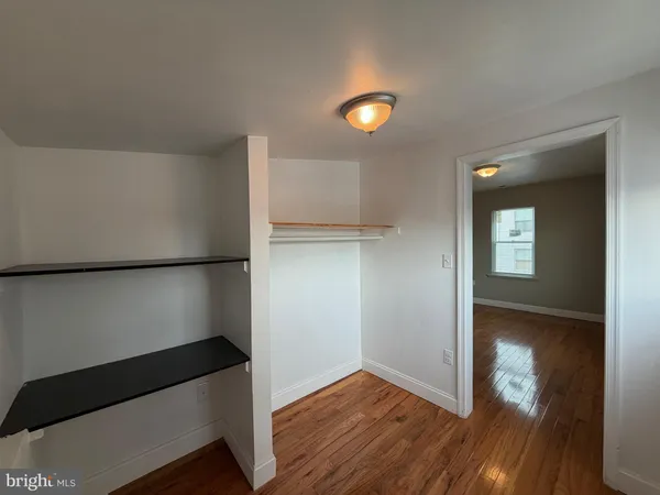 a view of hallway with wooden floor