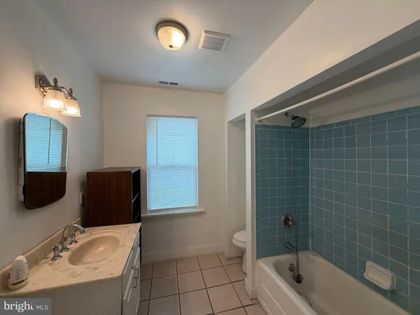 a bathroom with a bathtub and a toilet