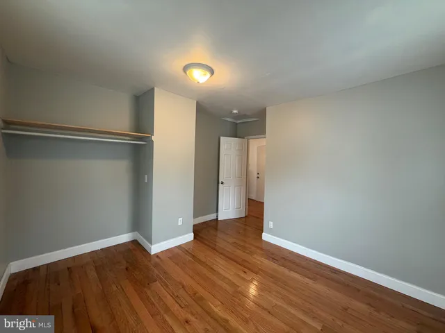 a view of room with window and wooden floor