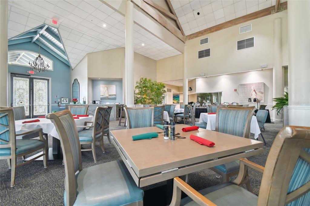 2587 Crystal Lake Drive Spring Hill, FL 34606 - Photo 54 of 63 a kitchen with a dining table chairs and white cabinets