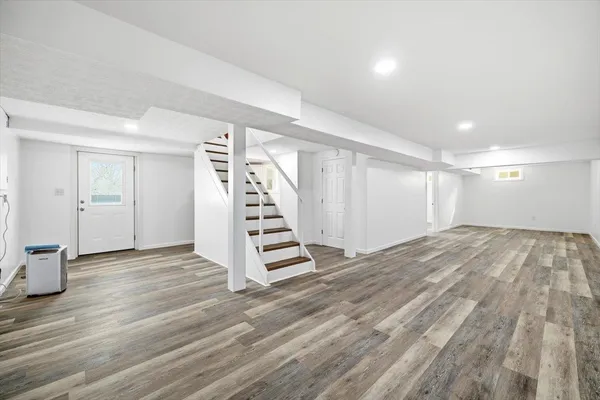 a view of wooden floor and windows in a room
