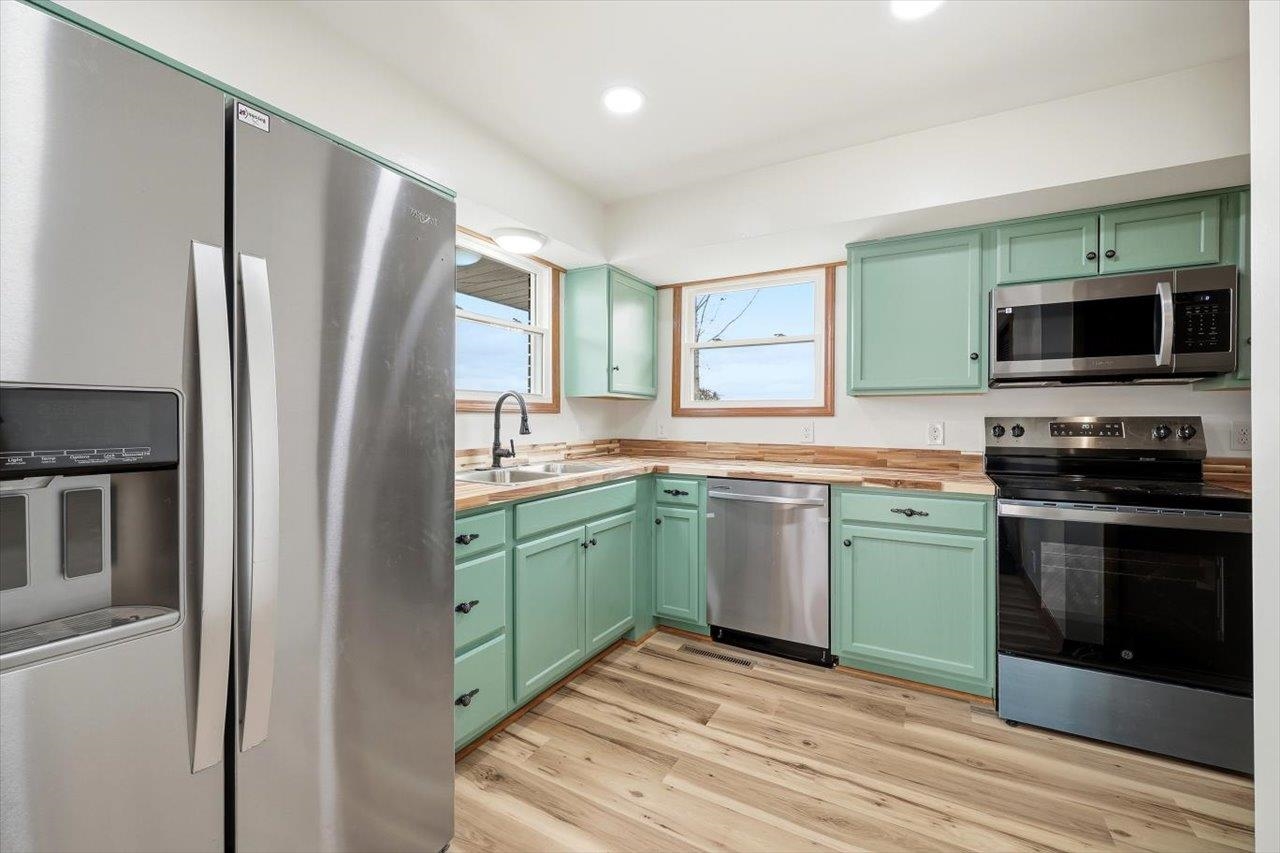 11 Partlow Street Staunton, VA 24401 - Photo 9 of 38 a kitchen with stainless steel appliances granite countertop a refrigerator a stove and a sink
