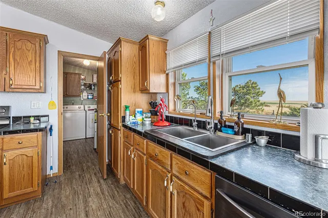 a kitchen with stainless steel appliances granite countertop sink stove and refrigerator