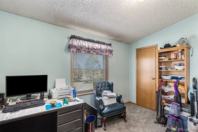 a bedroom with furniture and a flat screen tv
