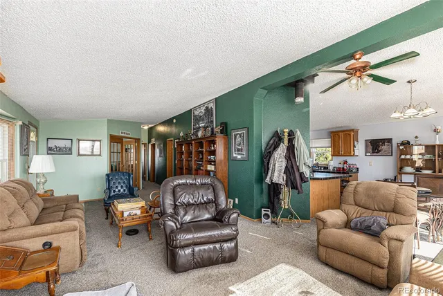 a living room with furniture and a gym