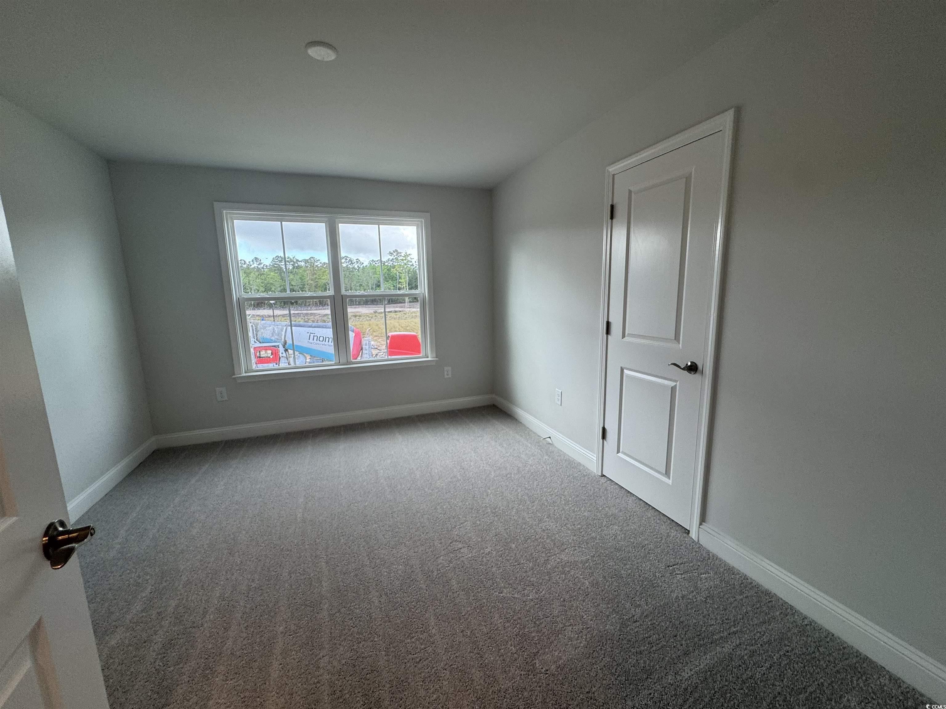 9409 Long Meadow Way Longs, SC 29568 - Photo 13 of 17 Carpeted spare room featuring baseboards