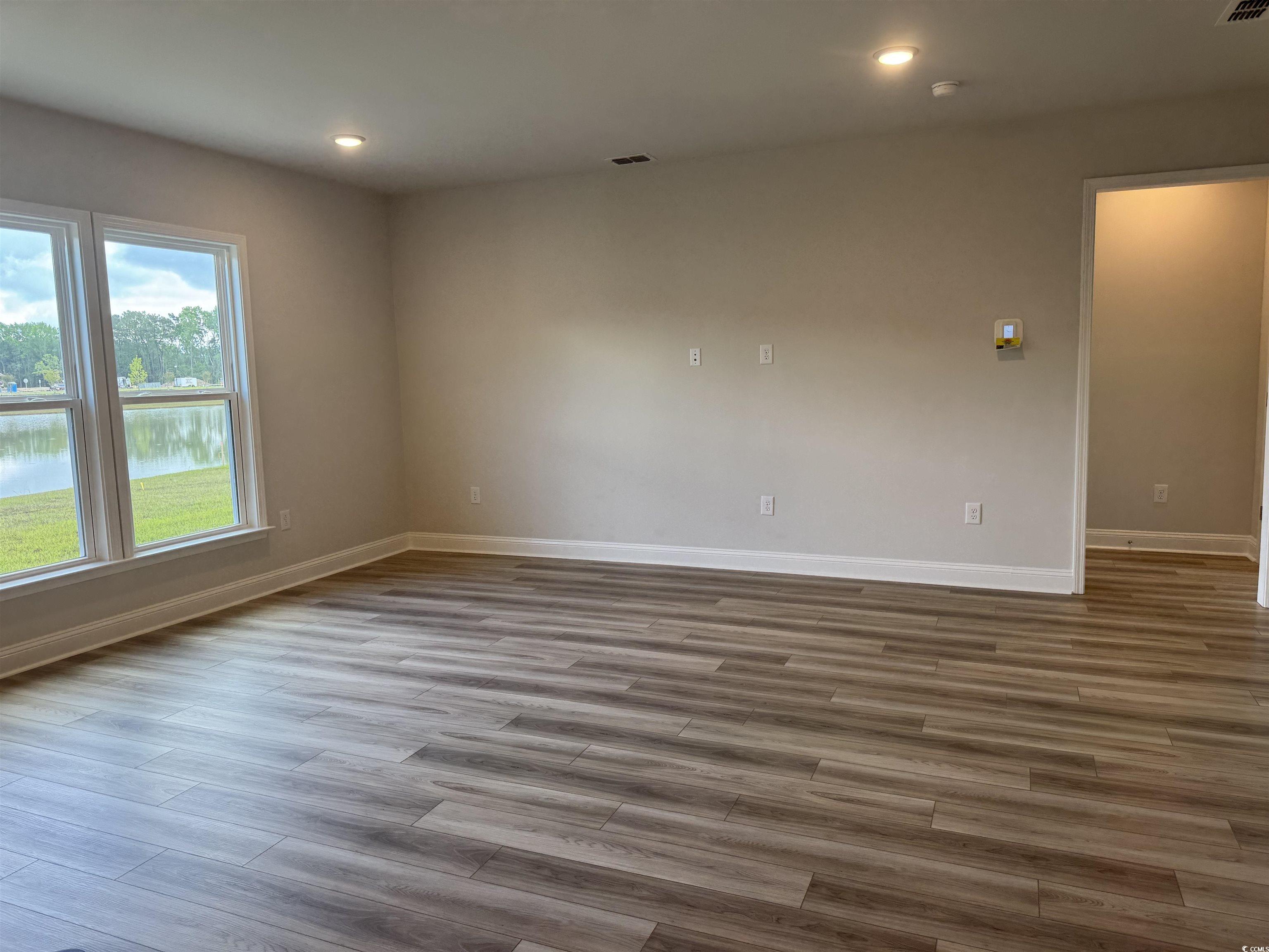 9409 Long Meadow Way Longs, SC 29568 - Photo 4 of 17 Spare room with baseboards, wood finished floors,