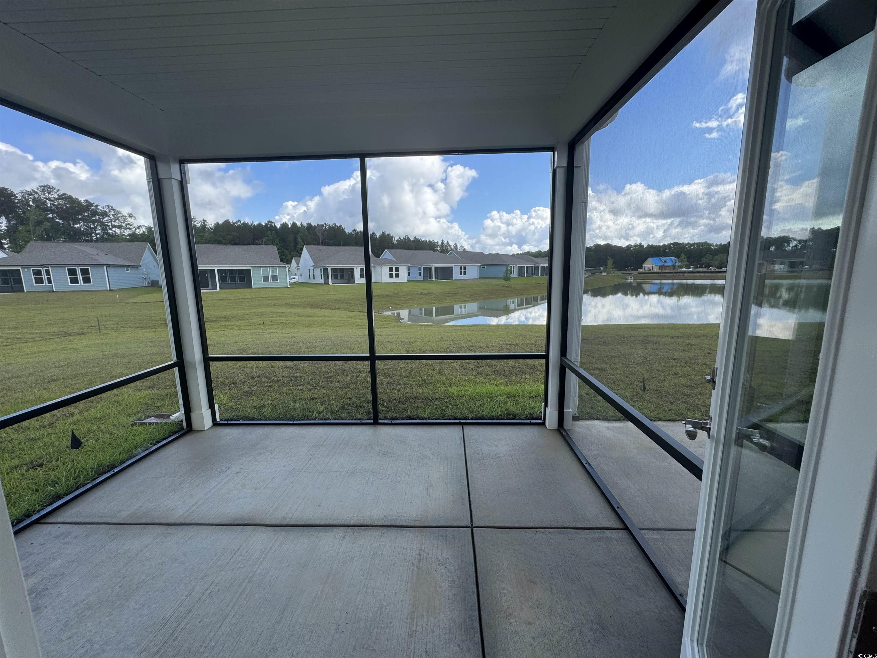 9409 Long Meadow Way Longs, SC 29568 - Photo 10 of 17 Unfurnished sunroom featuring a water view and a r