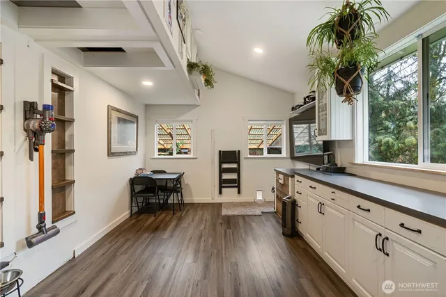 a large kitchen with stainless steel appliances granite countertop a large window and wooden floor