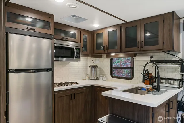 a kitchen with refrigerator a sink and cabinets