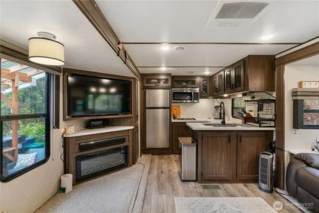 a kitchen with microwave a stove and refrigerator