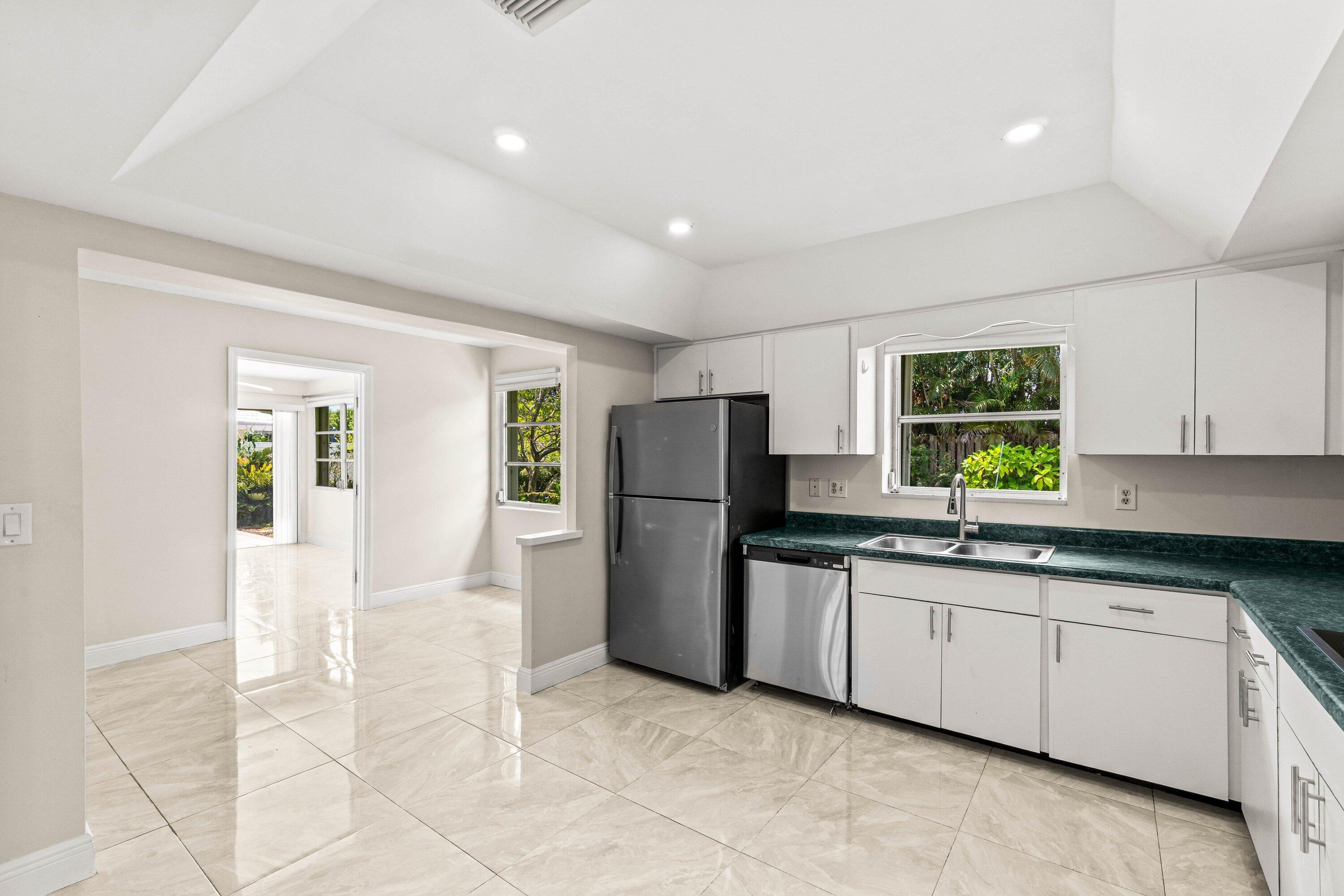 1290 Southwest 8th Street Boca Raton, FL 33486 - Photo 6 of 29 a kitchen with a sink window and refrigerator