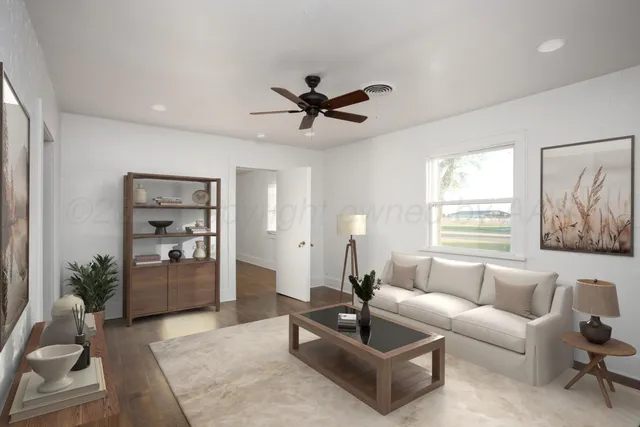 a living room with furniture and a large window