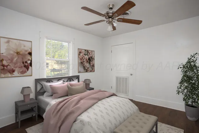 a spacious bedroom with a bed and a window