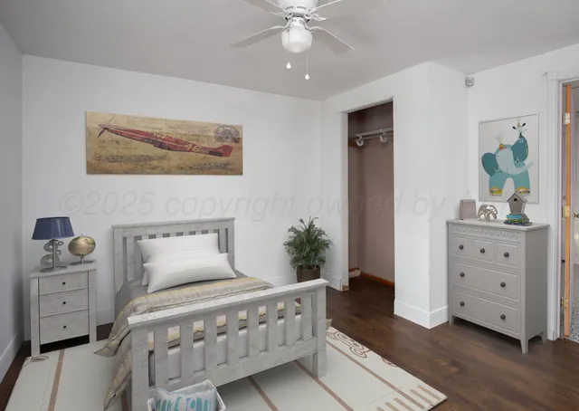 a bedroom with a bed and a dresser in it