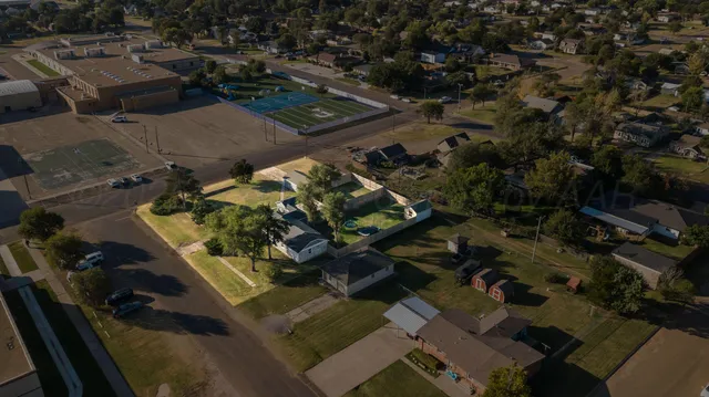 an aerial view of multiple houses with yard