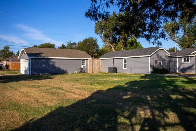 a front view of a house with yard and tree s