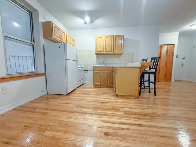 a view of a kitchen with furniture and wooden floor