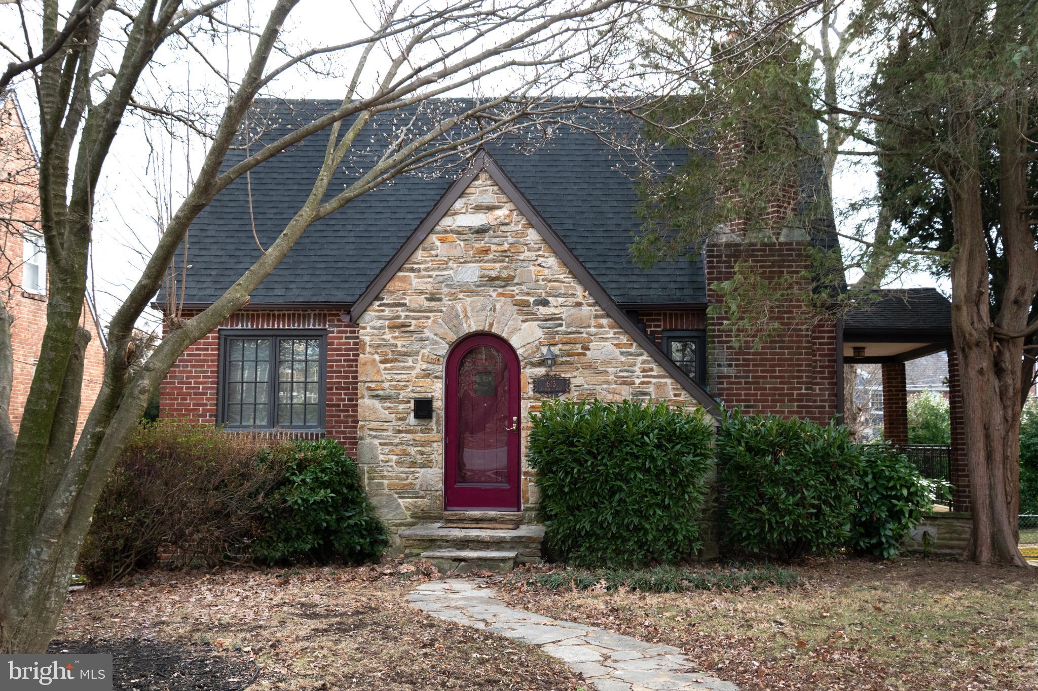 Charming stone cottage with vibrant entrance.