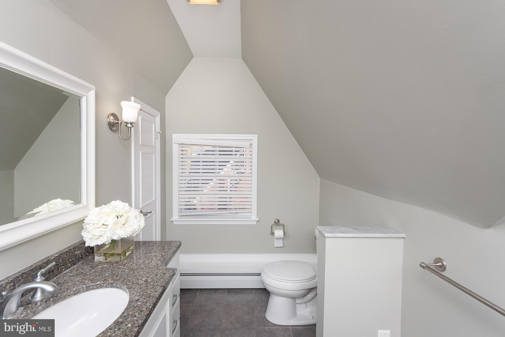 613 Anneslie Road Baltimore, MD 21212 - Photo 27 of 48 a bathroom with a granite countertop sink mirror vanity bathtub and a toilet