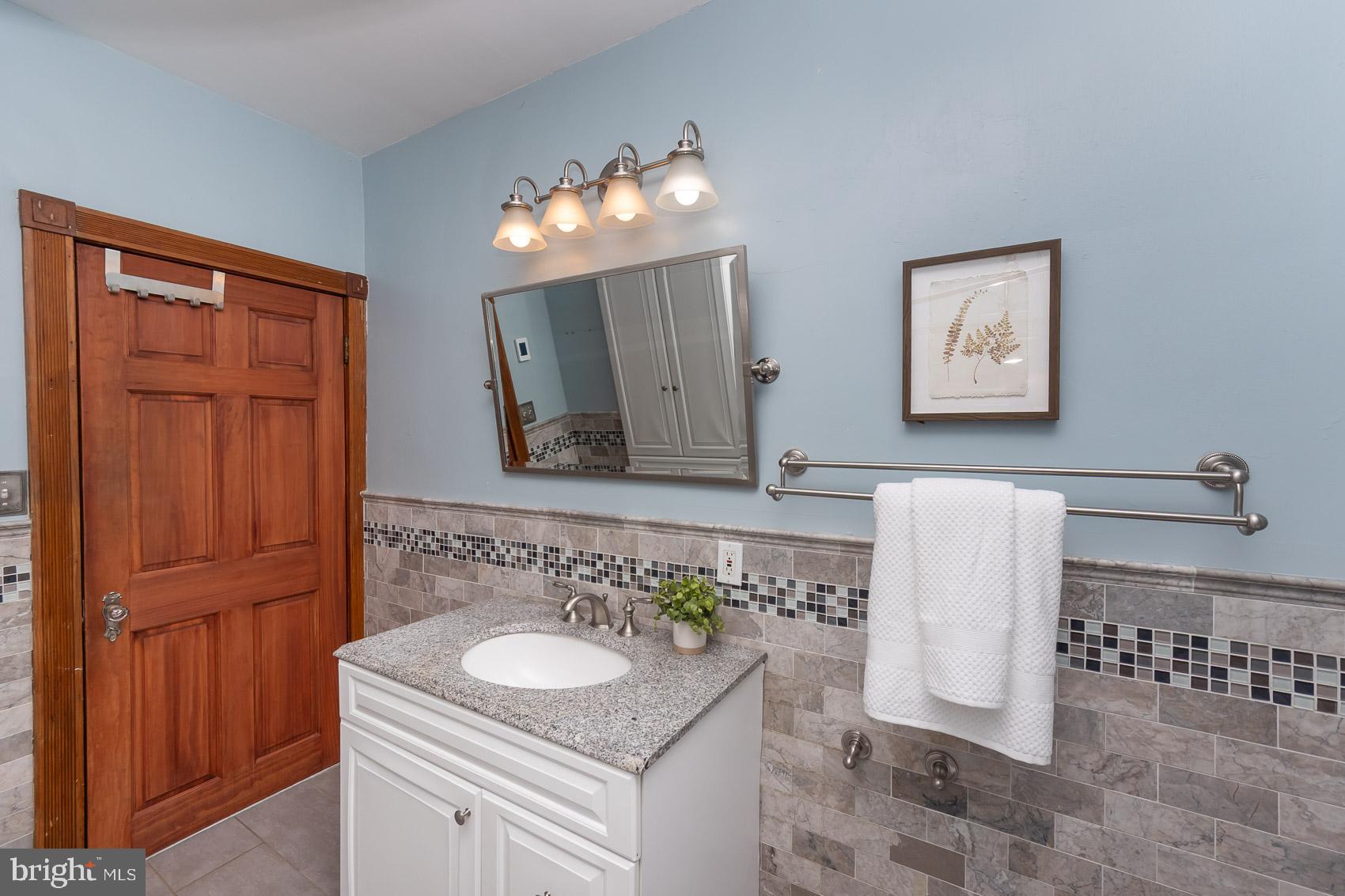 613 Anneslie Road Baltimore, MD 21212 - Photo 36 of 48 a bathroom with a sink and a mirror