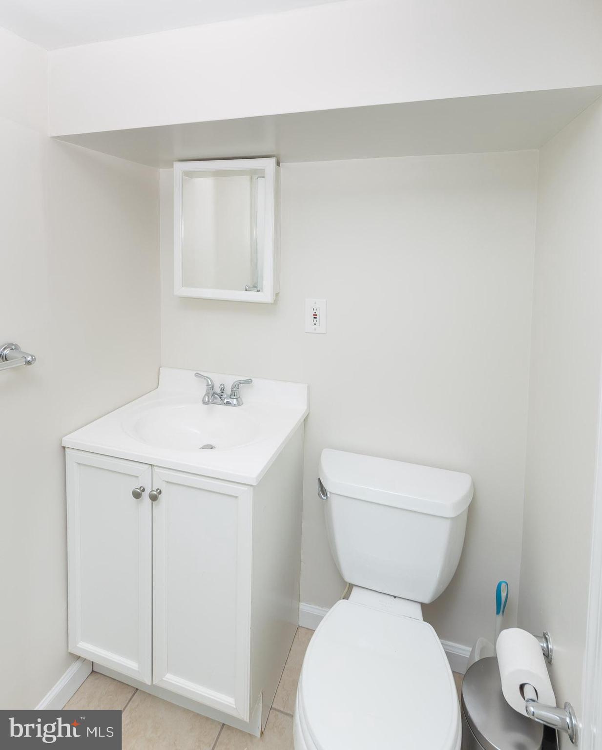 613 Anneslie Road Baltimore, MD 21212 - Photo 44 of 48 a bathroom with a toilet sink and mirror