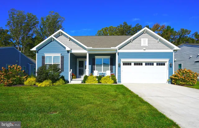 a front view of a house with a yard and porch