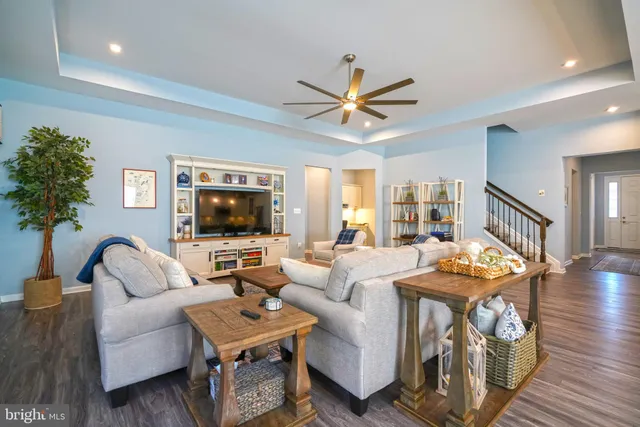 a dining room with stainless steel appliances granite countertop furniture wooden floor and a kitchen view