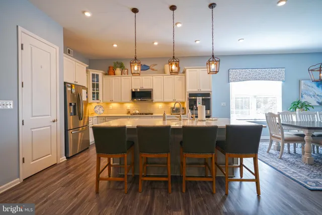 a kitchen with stainless steel appliances granite countertop white cabinets a sink and dishwasher