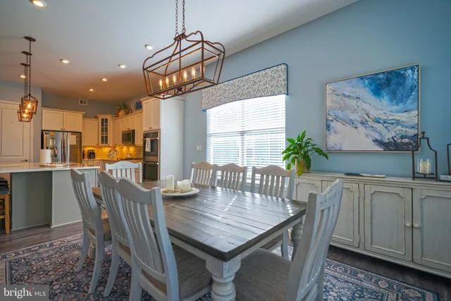 a spacious bedroom with a bed and a chandelier