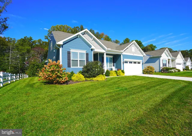 a living room with furniture a flat screen tv and wooden floor