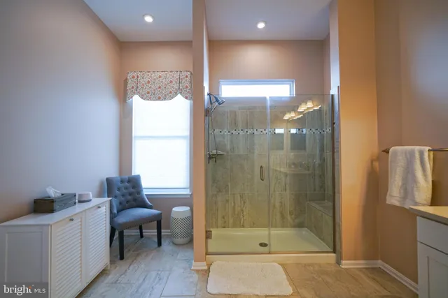 a living room with furniture and a ceiling fan