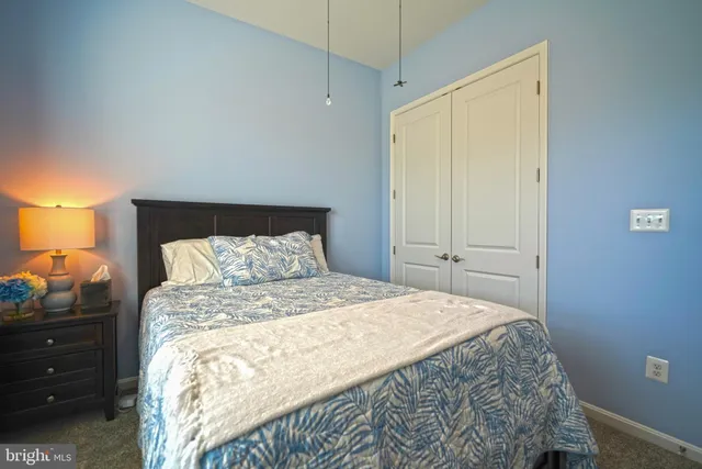 an aerial view of a house with a garden and lake view