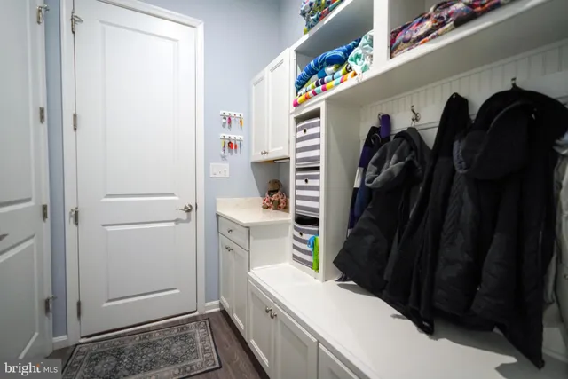 a living room with furniture a chandelier and a flat screen tv