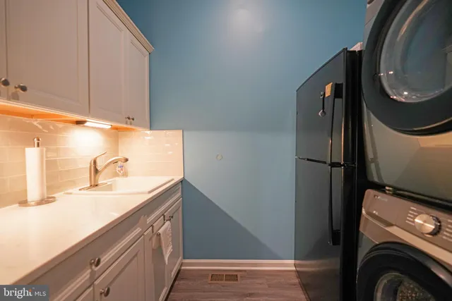 a patio with a table and chairs under an umbrella