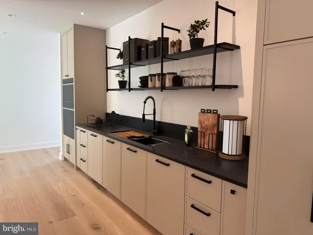 a kitchen with stainless steel appliances granite countertop a sink and cabinets