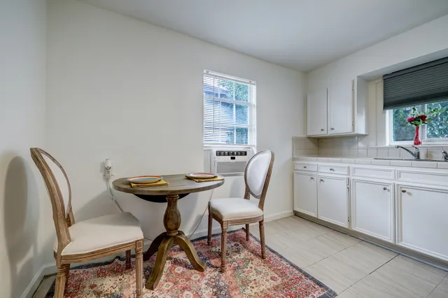 a view of a kitchen with a dining table and chair