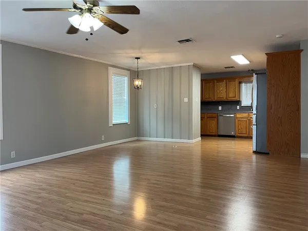 a kitchen with stainless steel appliances granite countertop a refrigerator sink and microwave