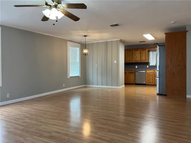 a kitchen with stainless steel appliances granite countertop a refrigerator sink and microwave