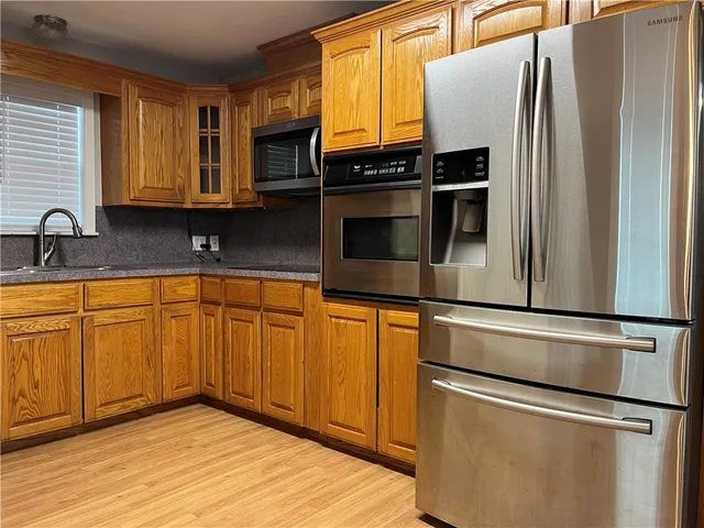 a kitchen with stainless steel appliances granite countertop a stove microwave and cabinets