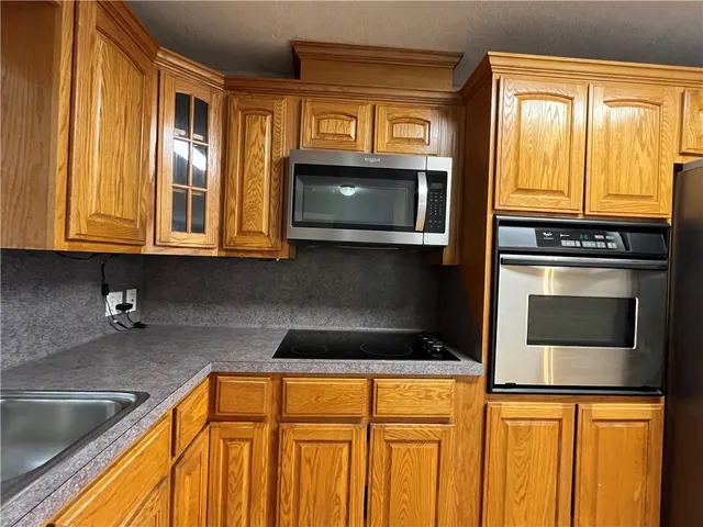a kitchen with stainless steel appliances granite countertop a sink and cabinets