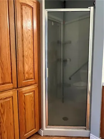a bathroom with a glass shower door