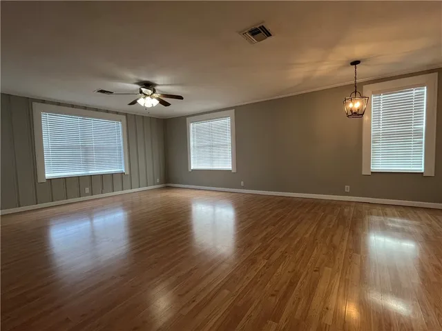 a view of a kitchen with wooden floor and a refrigerator