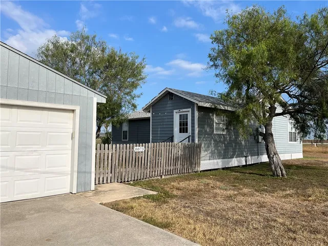 a view of a house with a backyard